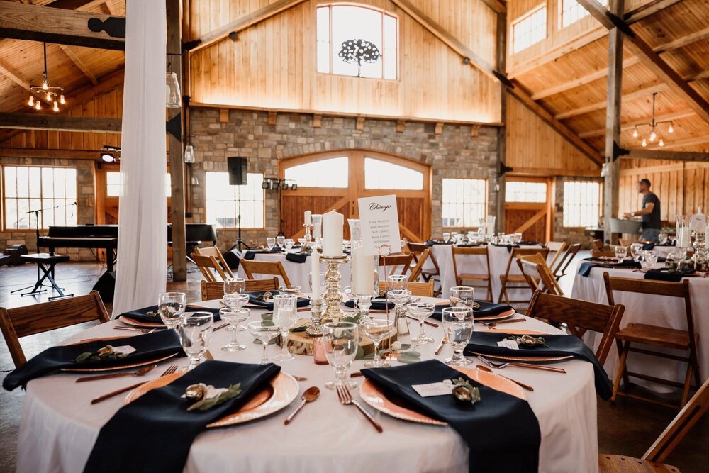 indoor wedding reception in venue with exposed wood beams