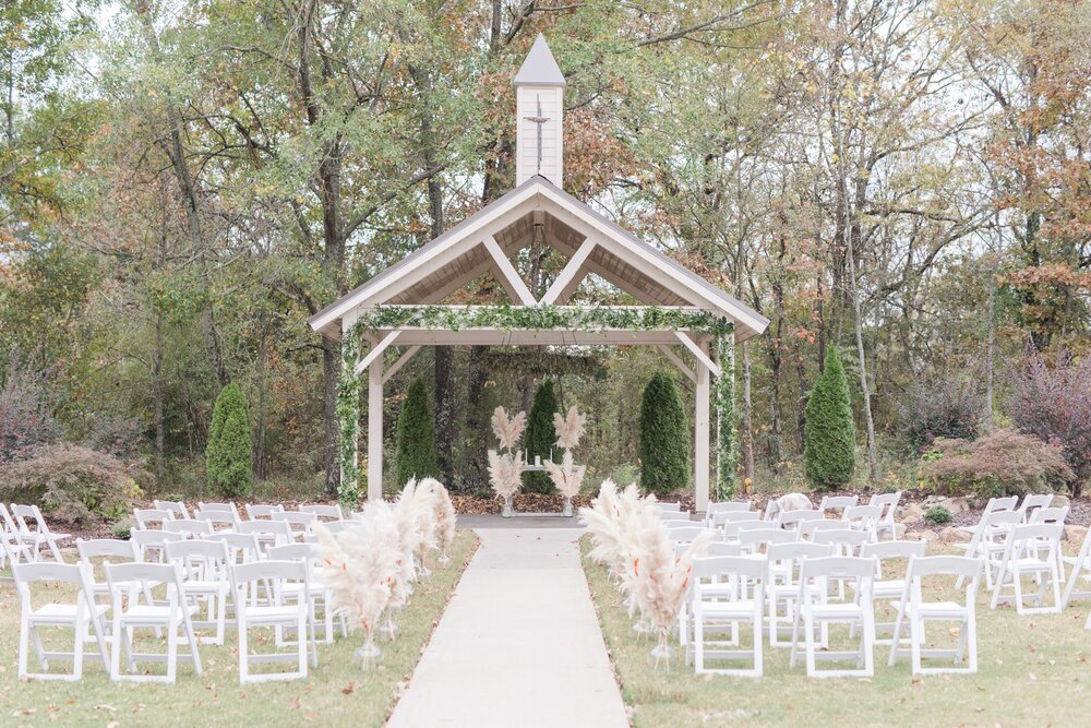 outdoor wedding ceremony with pampas grass decor