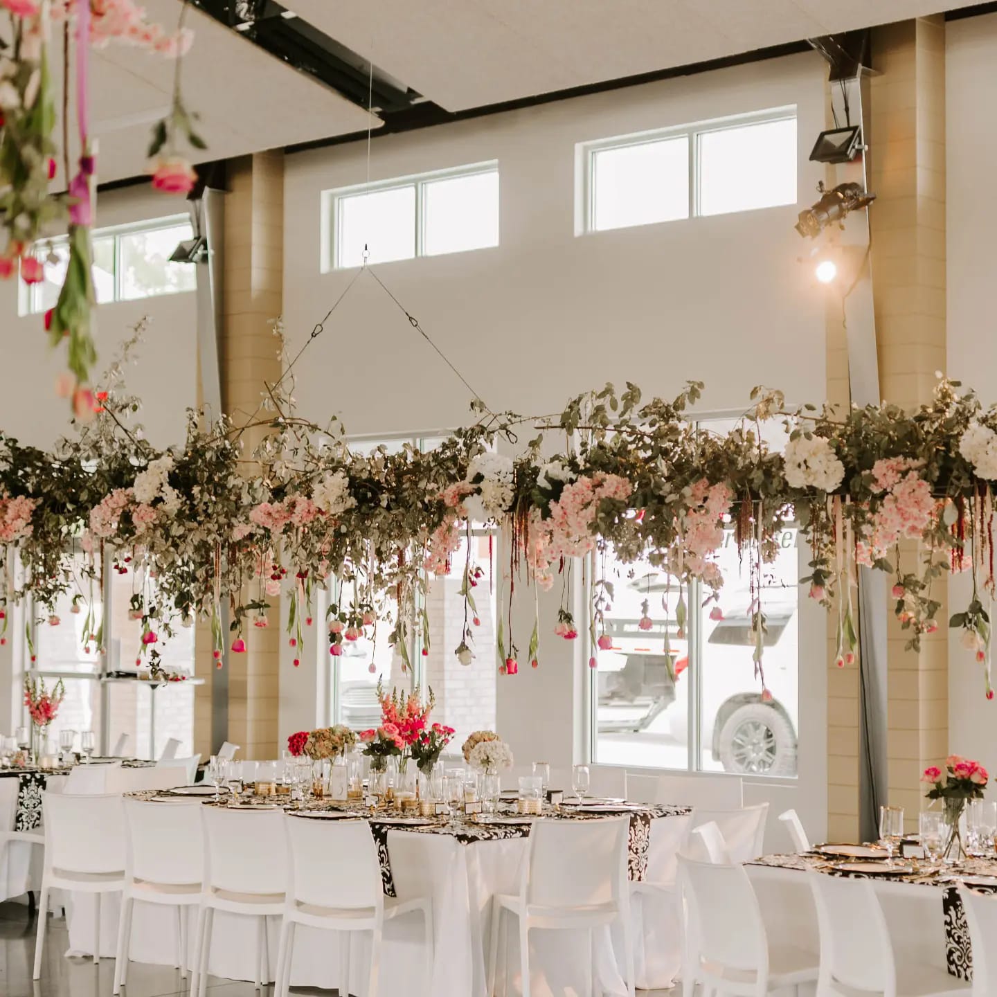 hanging floral arrangement over wedding reception table