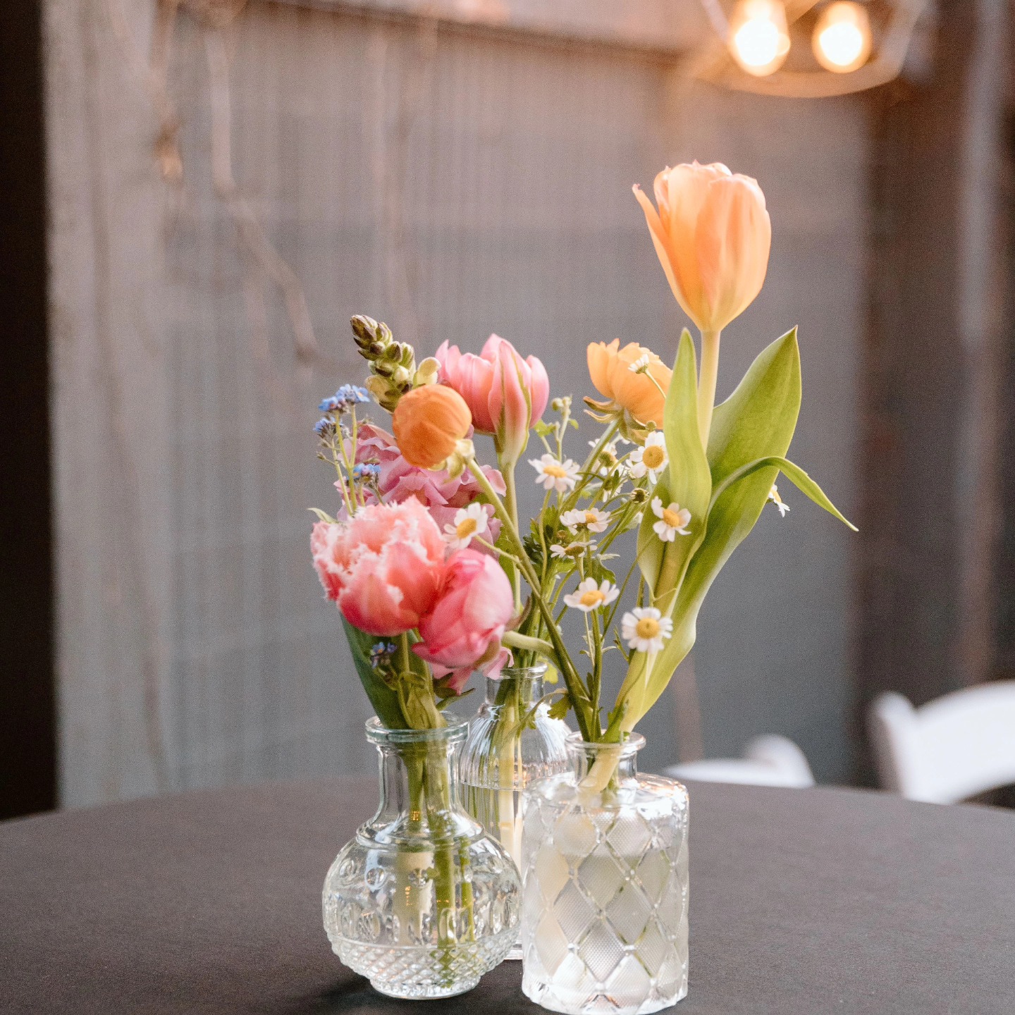 spring garden flowers in mismatched vases wedding centerpiece