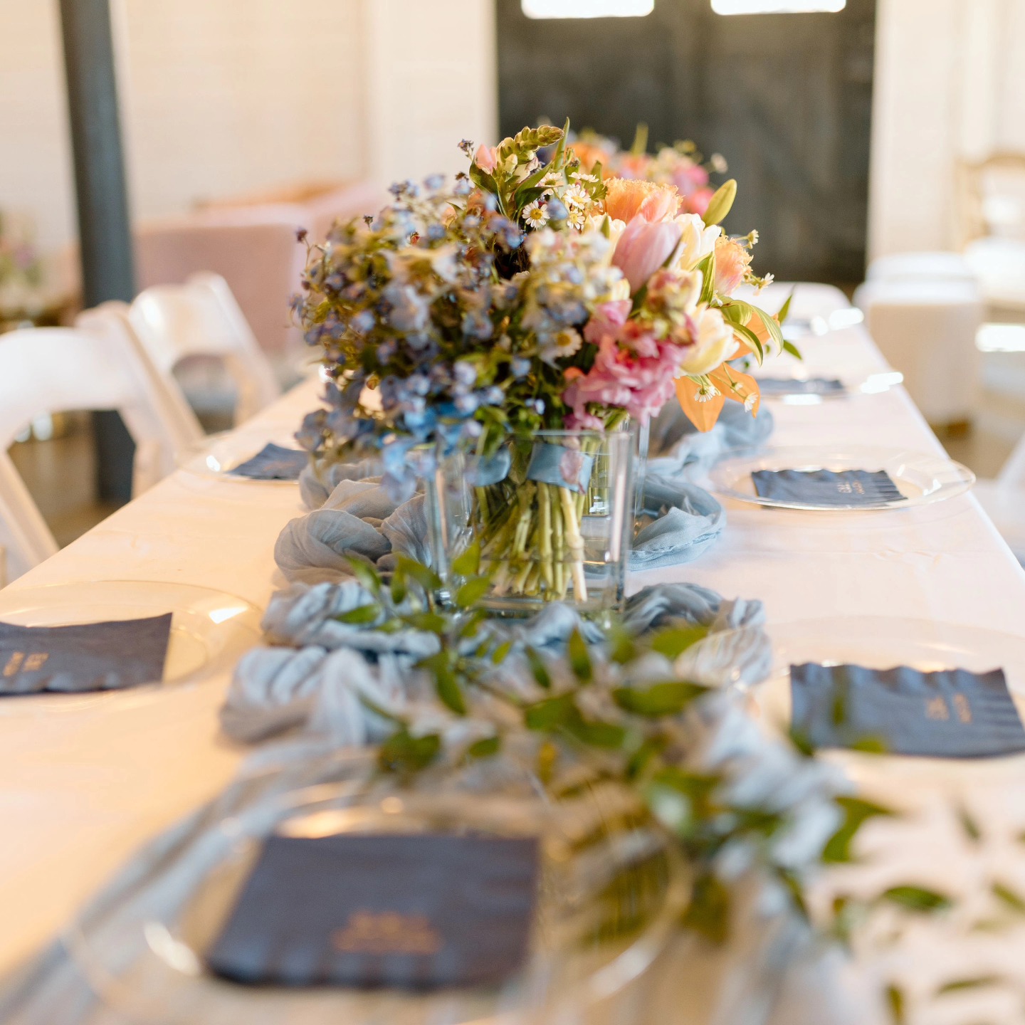 colorful spring wedding flowers with blue table runner