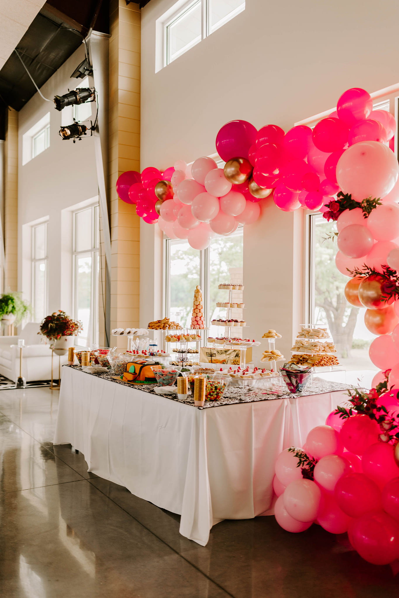 pink balloon arch over dessert table at party