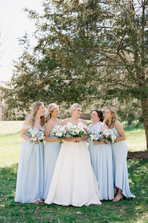 bride with bridesmaids in pale blue dresses