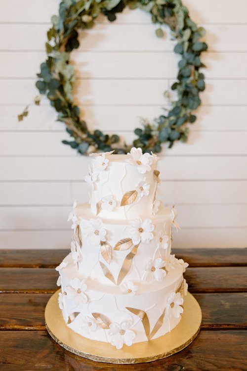 wedding cake with white and gold flowers