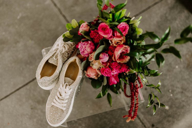 bride's sparkly sneakers with pink bridal bouquet
