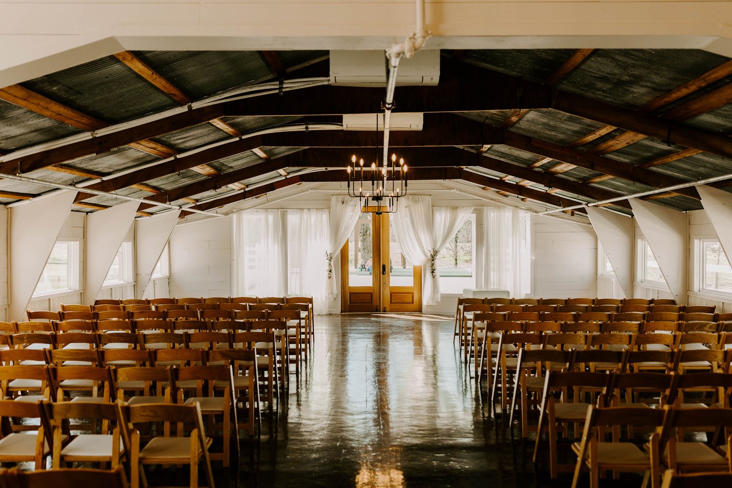 minimal indoor wedding venue with exposed beams