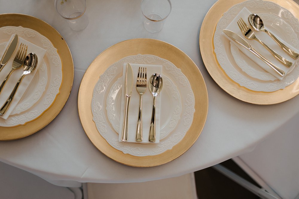 white and gold wedding cutlery and plates