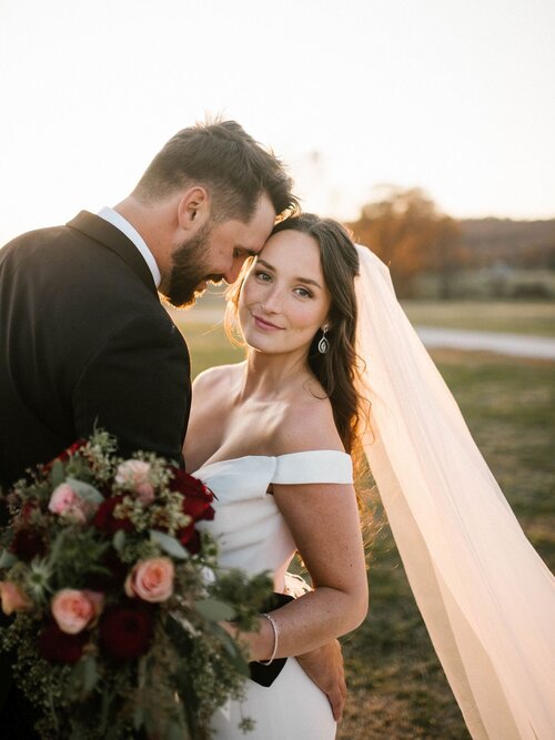 bride and groom embracing at sunset