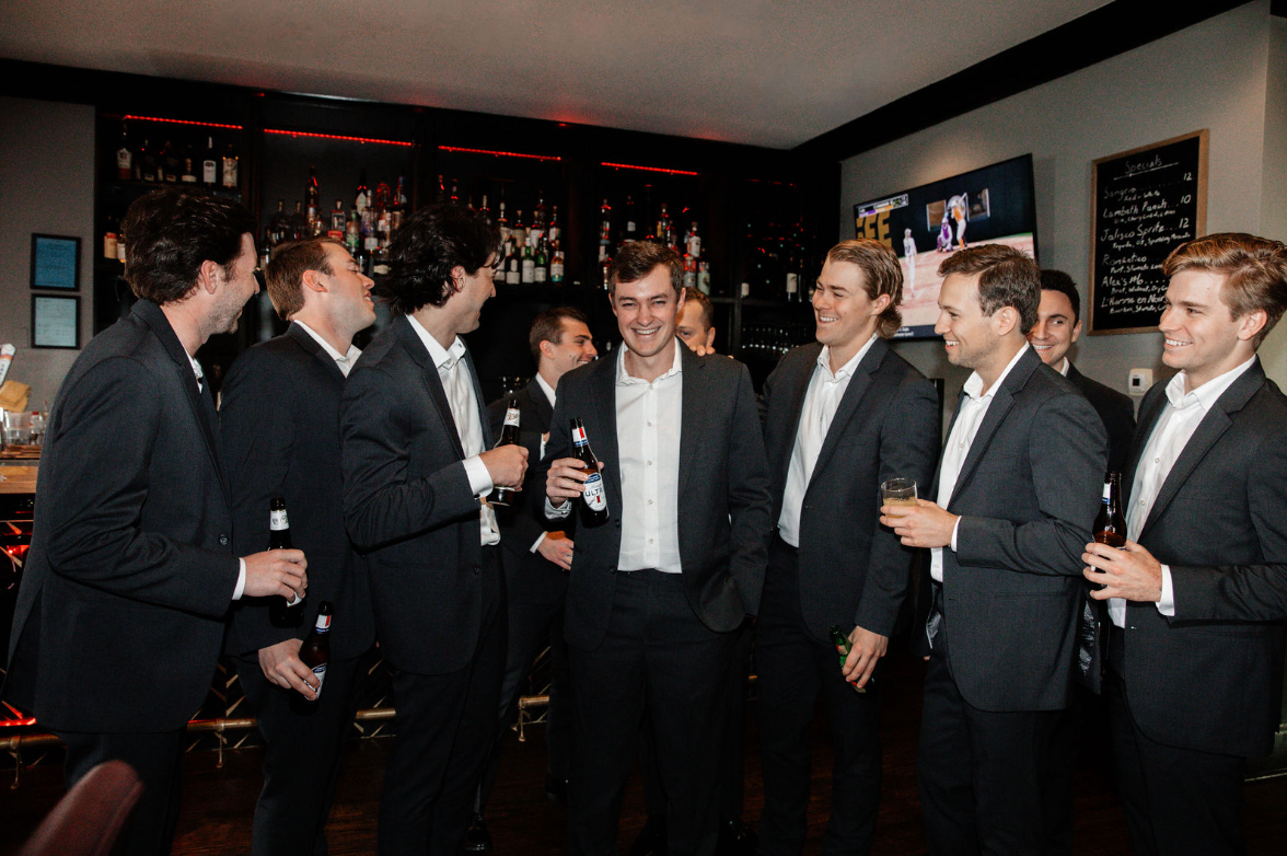 groom having a drink with groomsmen