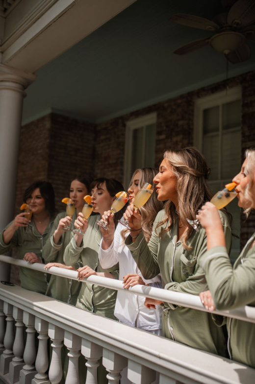 bride and bridesmaids drinking mimosas
