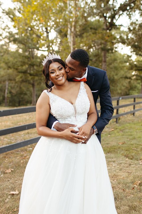 groom kissing bride on the cheek